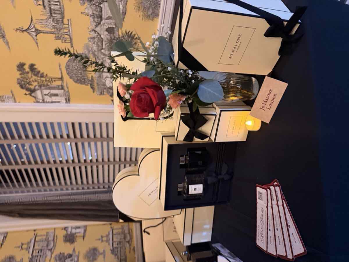The Jo Malone table with fragrances, a red rose and gift boxes