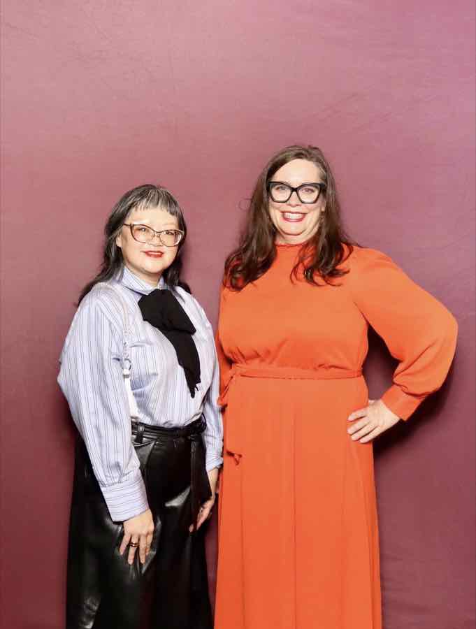 Two guests smiling together at the photo booth