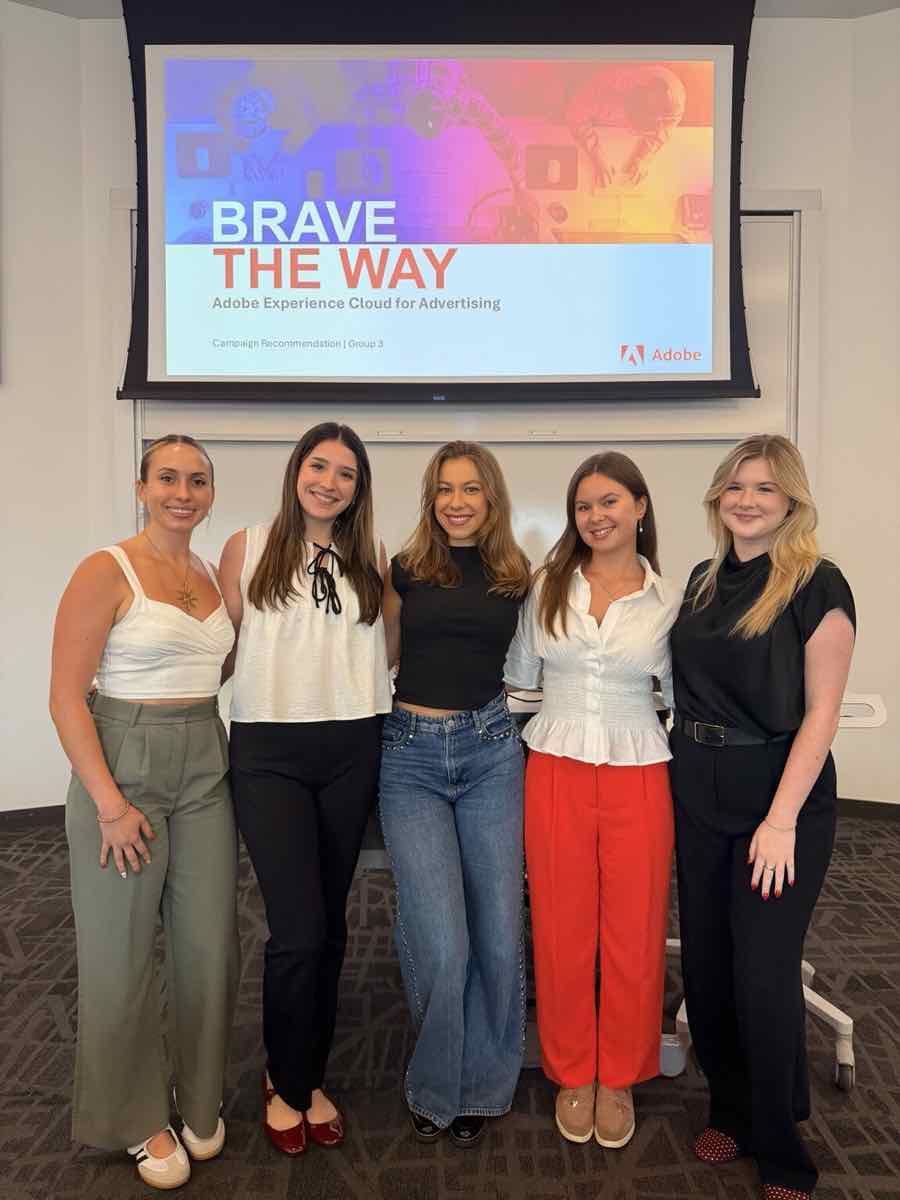 Taylor with four teammates in front of the Brave the Way title slide for Adobe