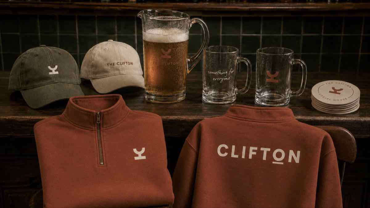 Rust and olive Clifton quarter-zips and caps on a bar