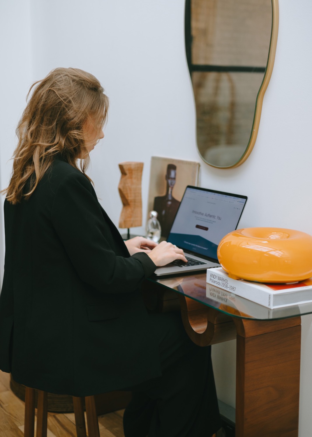Taylor Petersen at a desk with The Next Creative Solution website on screen