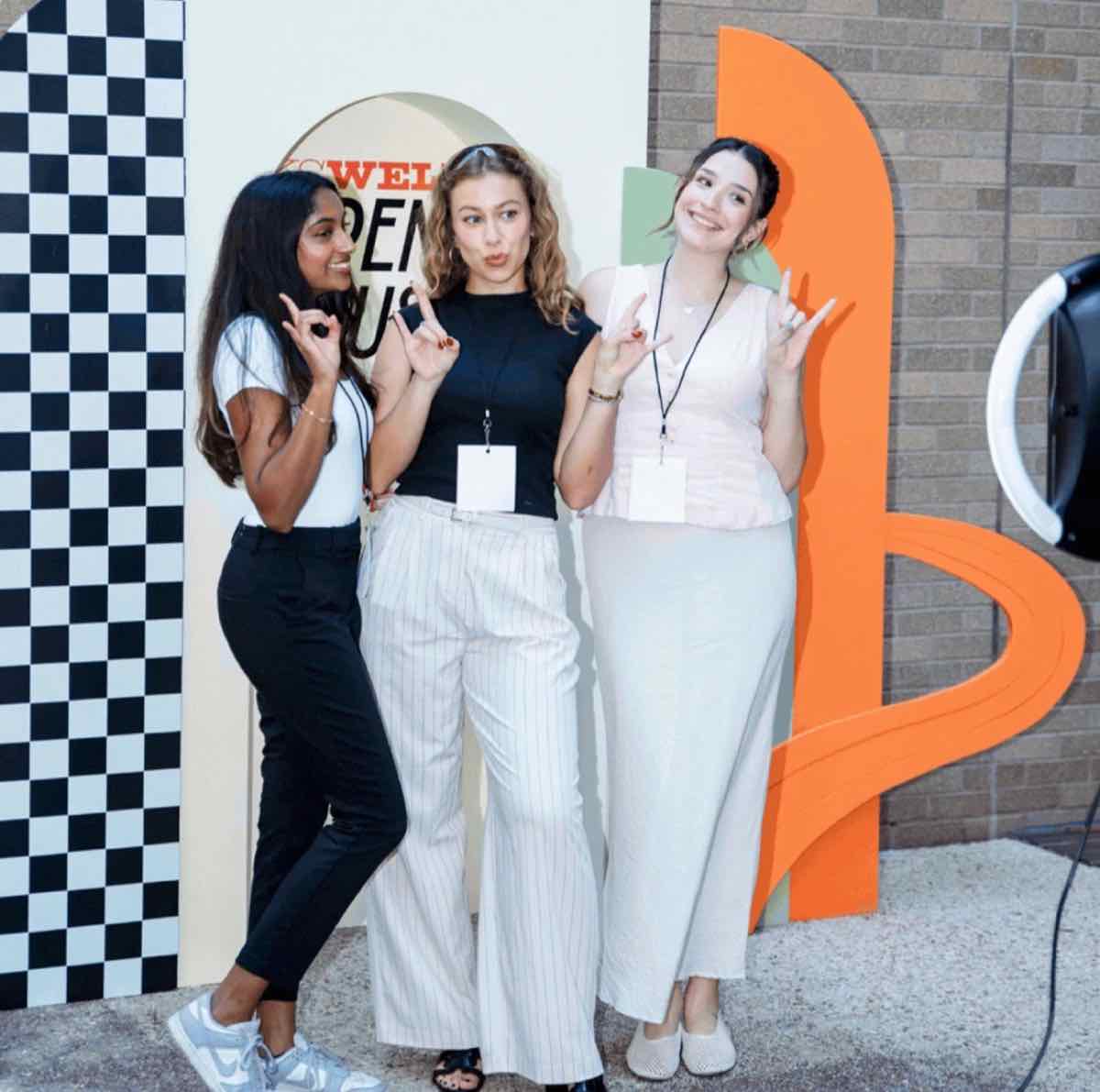 Taylor with two other attendees at the KS WELI photo wall