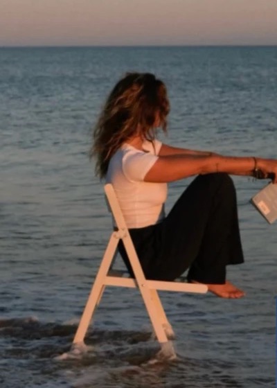 Mood board reference: a woman on a chair in the sea