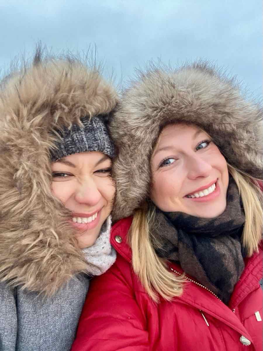 Taylor and a friend bundled up in fur-lined hoods in the Finnish winter