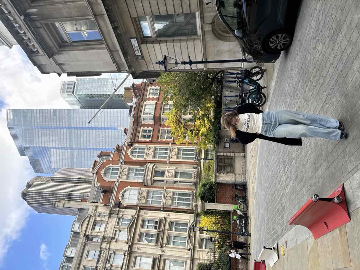 Taylor walking through the City of London between historic buildings and skyscrapers