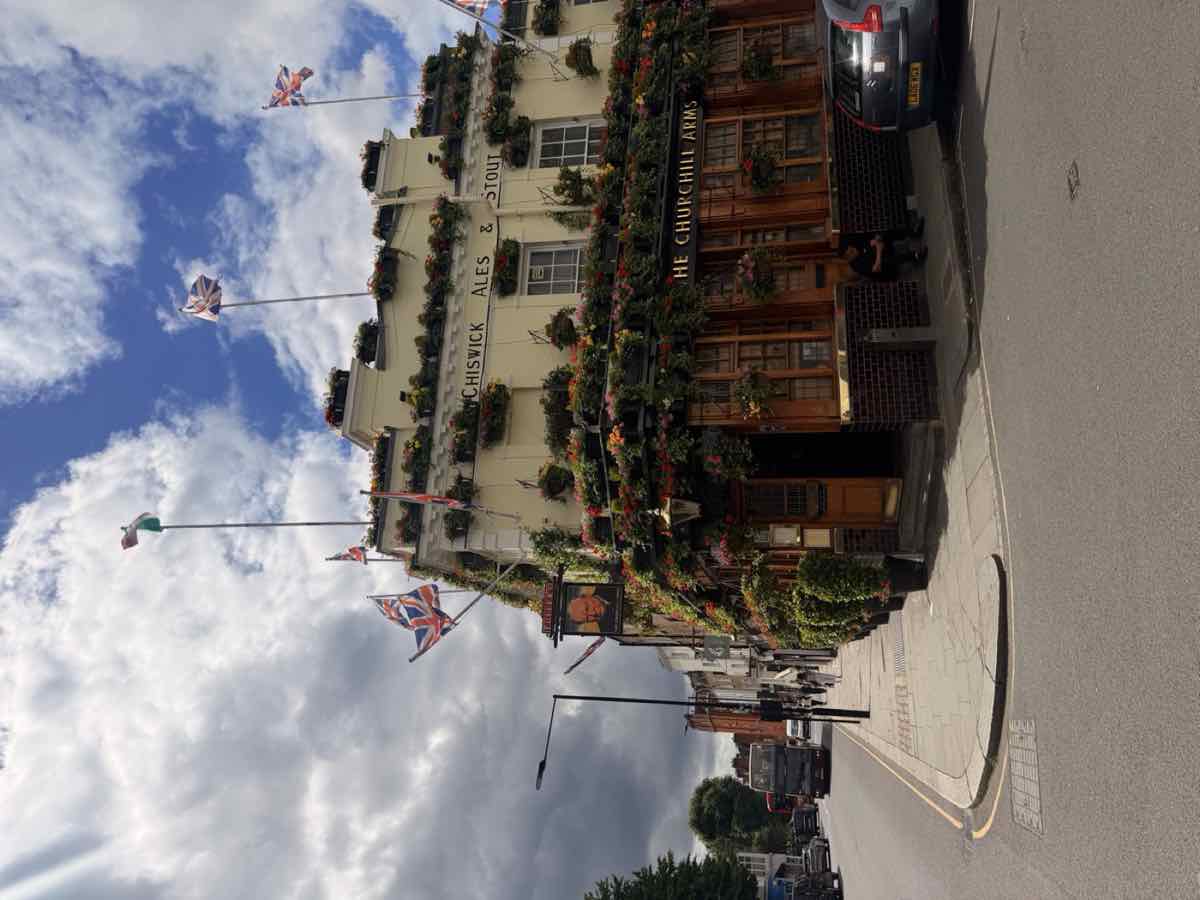 A classic London pub draped in flowers and Union Jack flags