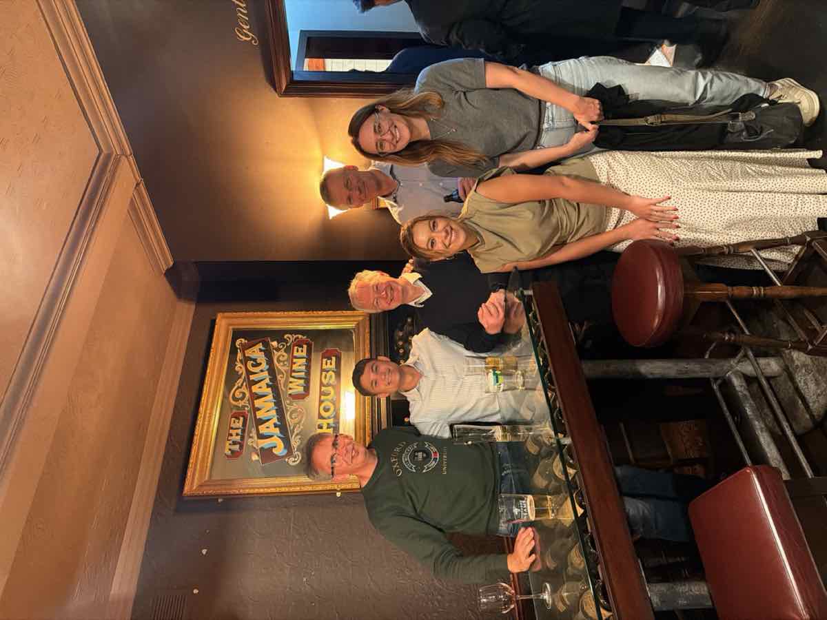 Taylor with the Avida International team at a wood-panelled London pub