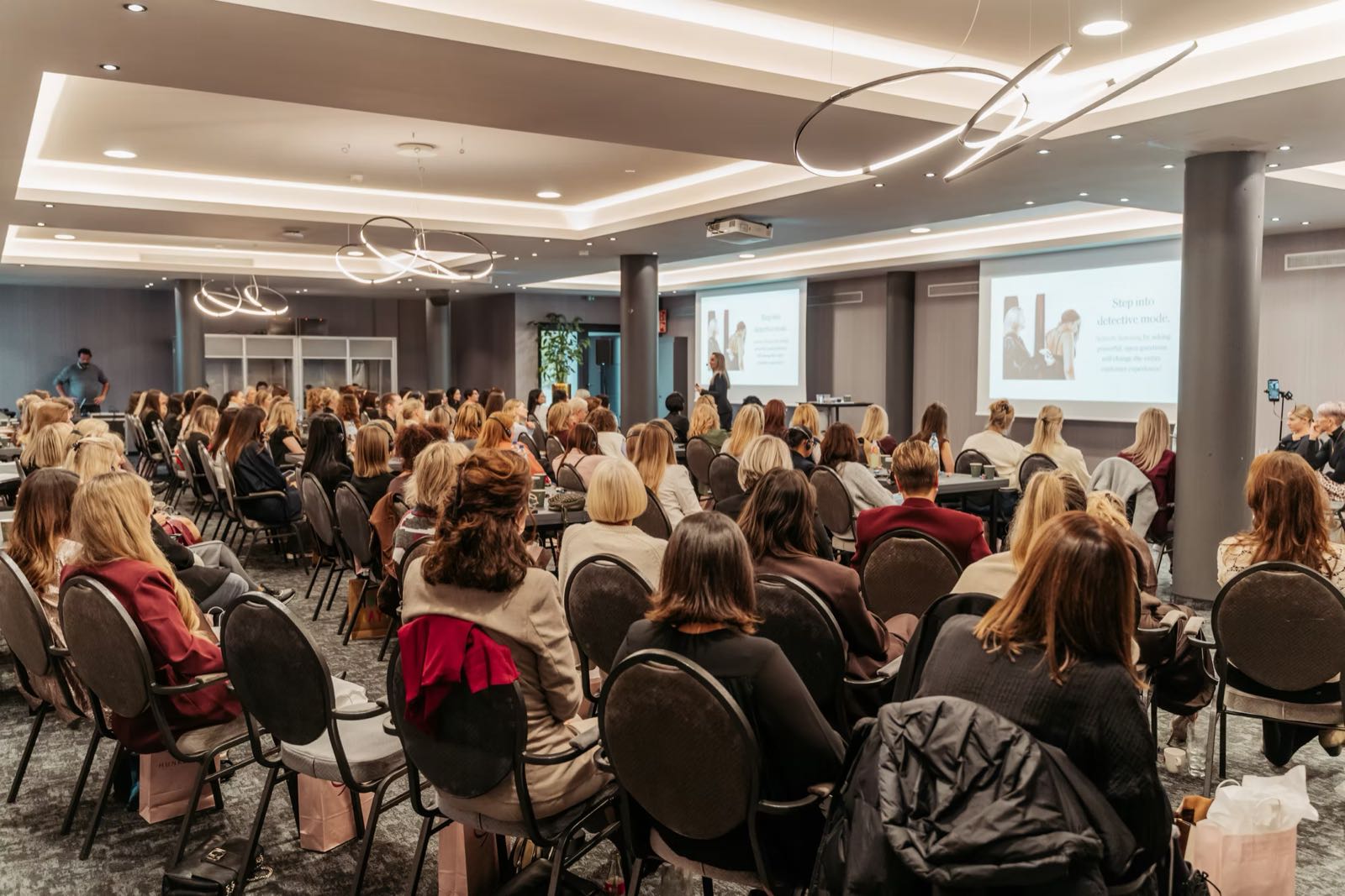 A full room of attendees watching a presentation at a The International Retail Academy event