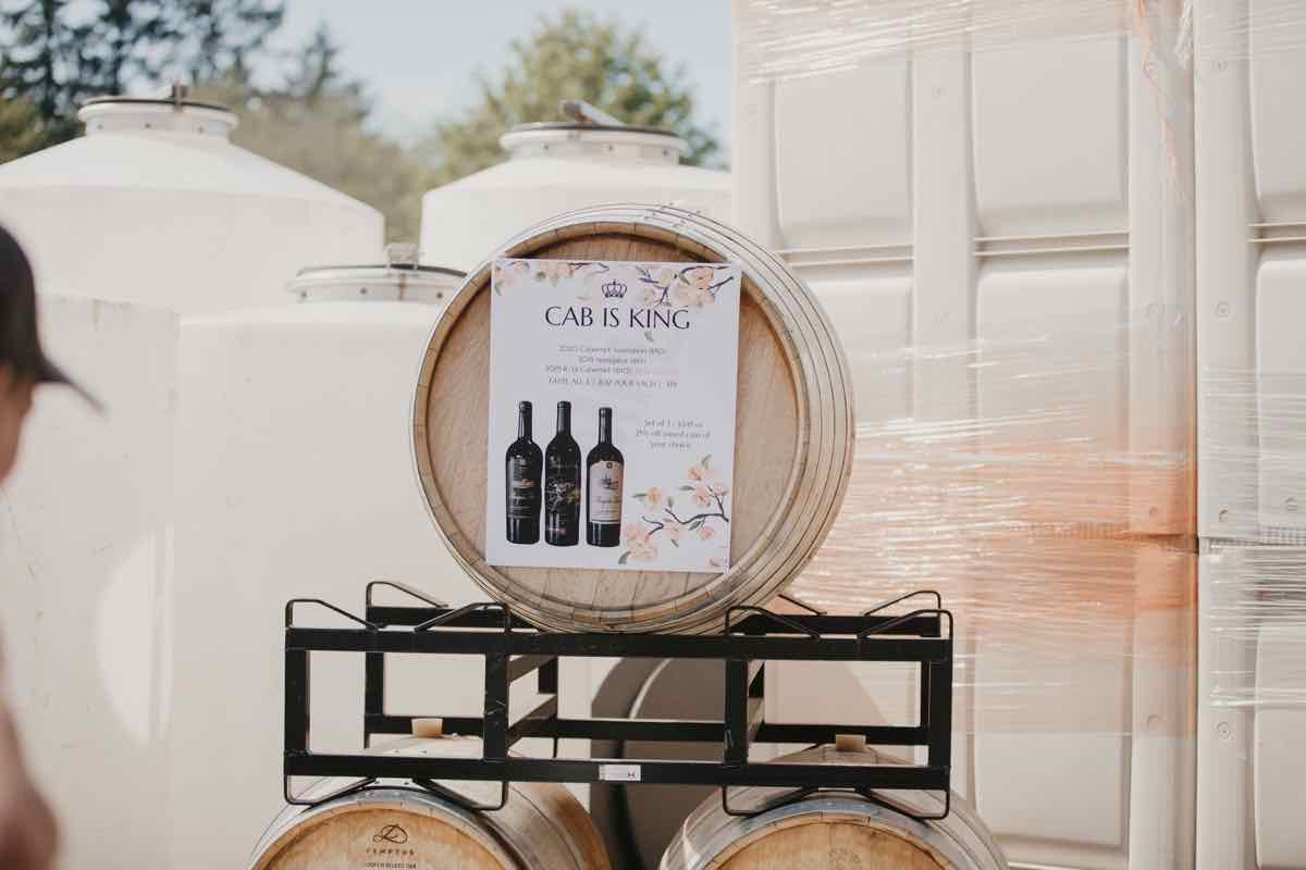 Event signage among wine barrels at Mosquito Fleet Winery